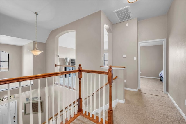 3306 Castleton Dr, Killeen, TX 76542 - hallway with arched walkways, carpet floors, an upstairs landing, baseboards, and visible vents