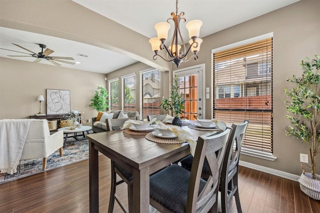 3306 Castleton Dr, Killeen, TX 76542 - dining room featuring dark wood finished floors, a chandelier, arched walkways, and ceiling fan