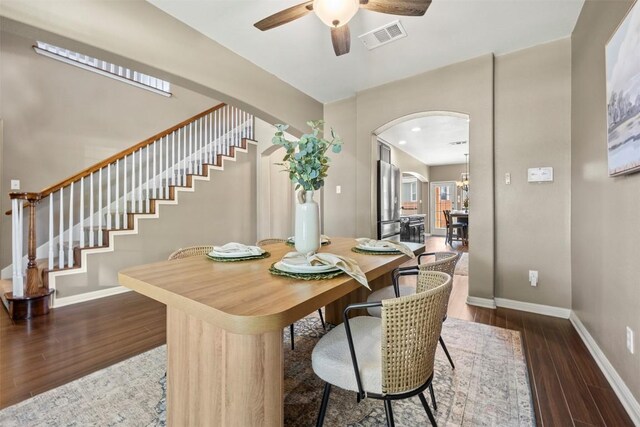 3306 Castleton Dr, Killeen, TX 76542 - dining room with arched walkways, ceiling fan, stairway, and dark wood-type flooring