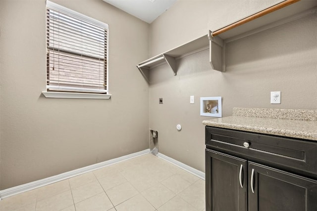 3306 Castleton Dr, Killeen, TX 76542 - washroom with electric dryer hookup, hookup for a washing machine, gas dryer hookup, cabinet space, and light tile patterned flooring