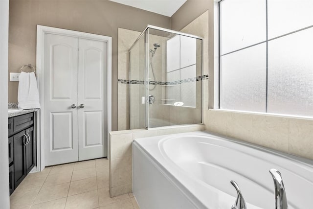 3306 Castleton Dr, Killeen, TX 76542 - full bathroom featuring a garden tub, a stall shower, tile patterned flooring, and vanity
