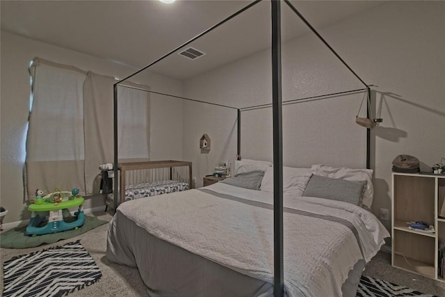 carpeted bedroom with visible vents and baseboards