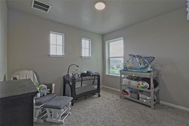interior space featuring visible vents, carpet flooring, and baseboards