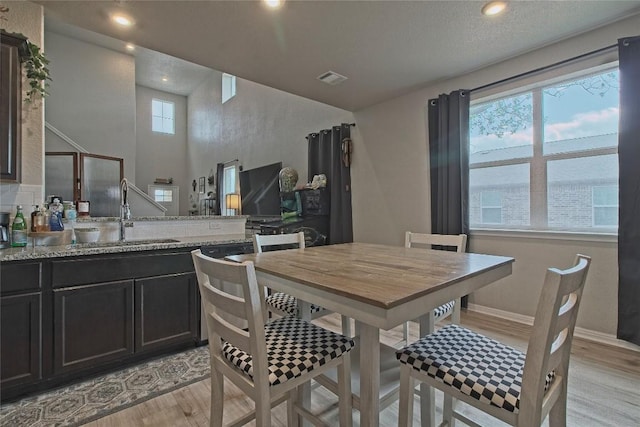 dining room featuring visible vents, light wood-type flooring, recessed lighting, and baseboards