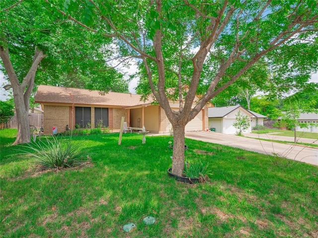 view of front of house featuring a front lawn, a garage, brick siding, concrete driveway, and fence