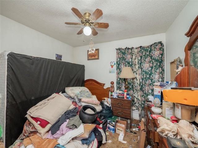 bedroom with a ceiling fan and a textured ceiling