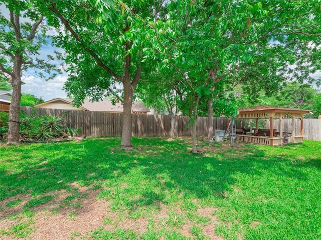 view of yard featuring a gazebo and a fenced backyard
