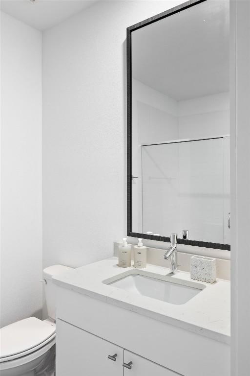 bathroom with toilet and vanity