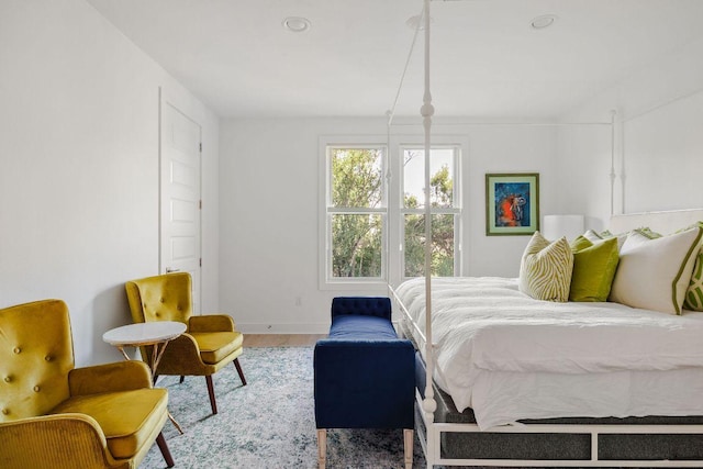 bedroom with wood finished floors and baseboards