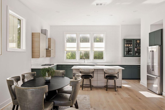 dining space with visible vents and light wood finished floors