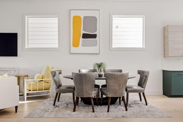 dining room featuring wood finished floors and baseboards