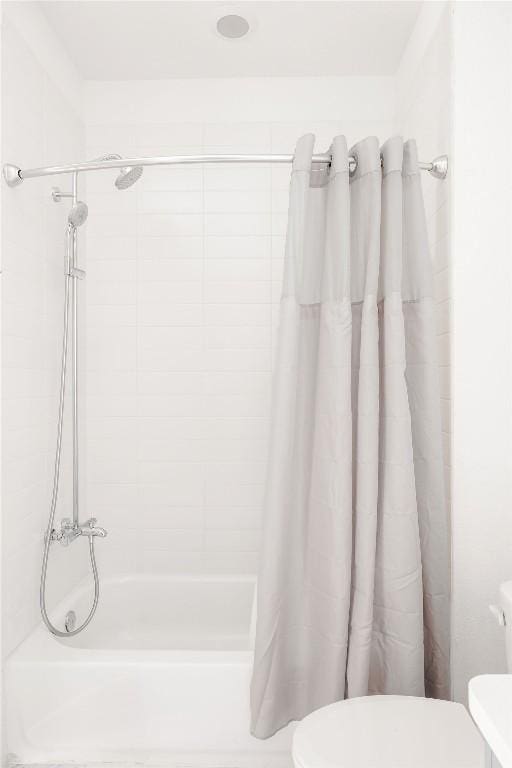full bath with toilet and a shower with curtain