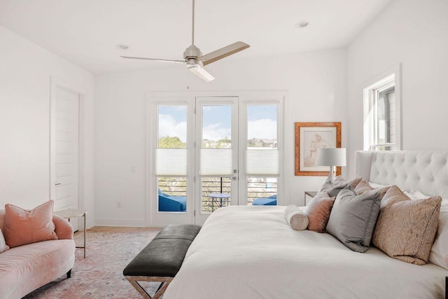 carpeted bedroom featuring baseboards, access to outside, and ceiling fan