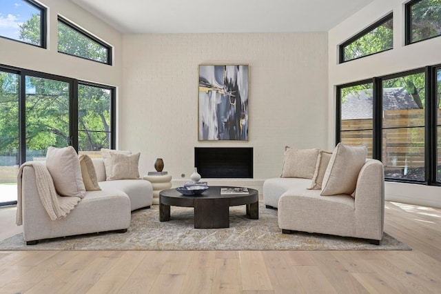 2001 Circle Hvn, Austin, TX 78741 - living area featuring a towering ceiling, plenty of natural light, and hardwood / wood-style floors