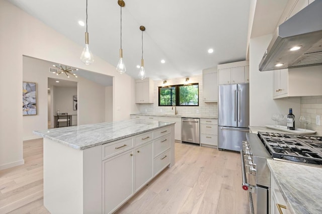 2001 Circle Hvn, Austin, TX 78741 - kitchen with high end appliances, a sink, under cabinet range hood, vaulted ceiling, and light wood-style floors