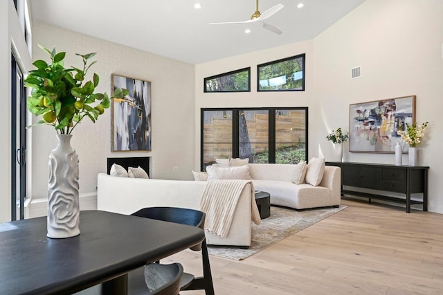 2001 Circle Hvn, Austin, TX 78741 - living area featuring light wood-style floors, plenty of natural light, recessed lighting, a ceiling fan, and a towering ceiling