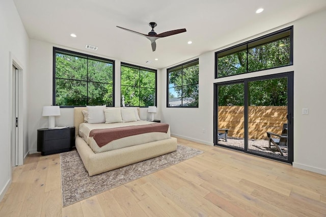 2001 Circle Hvn, Austin, TX 78741 - bedroom featuring access to exterior, multiple windows, hardwood / wood-style flooring, recessed lighting, and baseboards