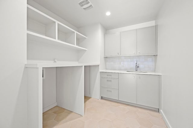 2001 Circle Hvn, Austin, TX 78741 - washroom featuring a sink, light tile patterned floors, and recessed lighting