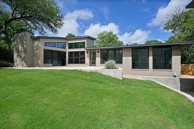 2001 Circle Hvn, Austin, TX 78741 - rear view of property featuring stucco siding and a yard