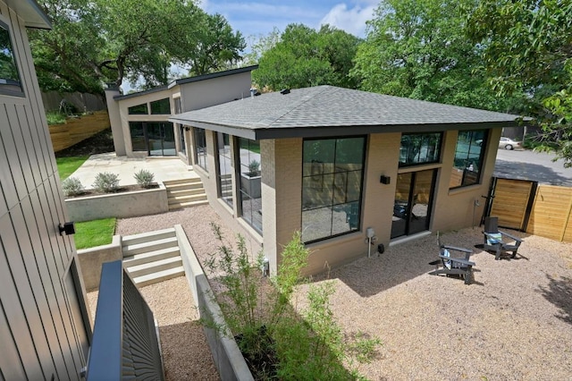 2001 Circle Hvn, Austin, TX 78741 - rear view of house with roof with shingles and a patio area