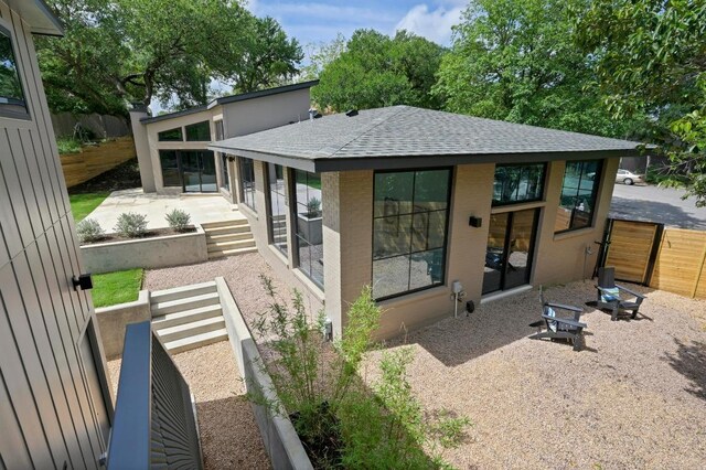 2001 Circle Hvn, Austin, TX 78741 - rear view of house with roof with shingles and a patio