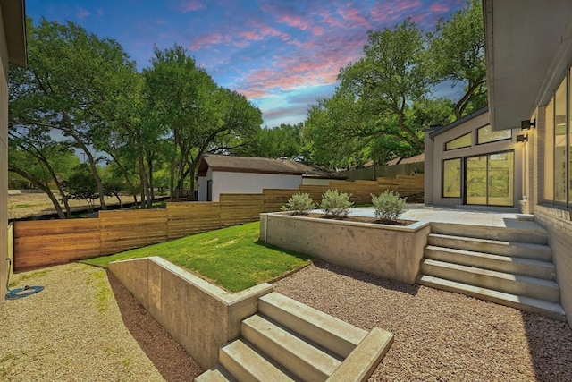 2001 Circle Hvn, Austin, TX 78741 - yard at dusk featuring a patio