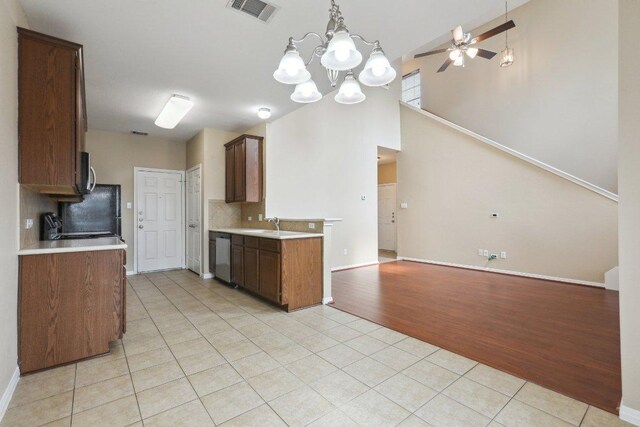 kitchen featuring stainless steel appliances, light tile patterned flooring, visible vents, light countertops, and ceiling fan with notable chandelier