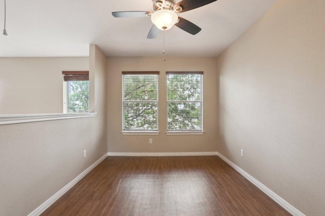 unfurnished room featuring a ceiling fan, wood finished floors, and baseboards