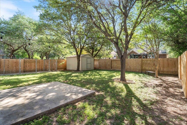 view of yard with an outdoor structure, a shed, a fenced backyard, and a patio area