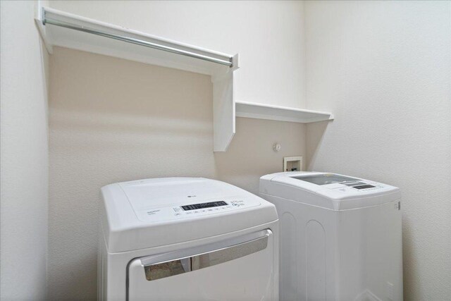 laundry area featuring washer and clothes dryer and laundry area