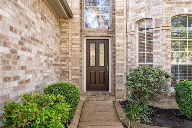 property entrance with brick siding
