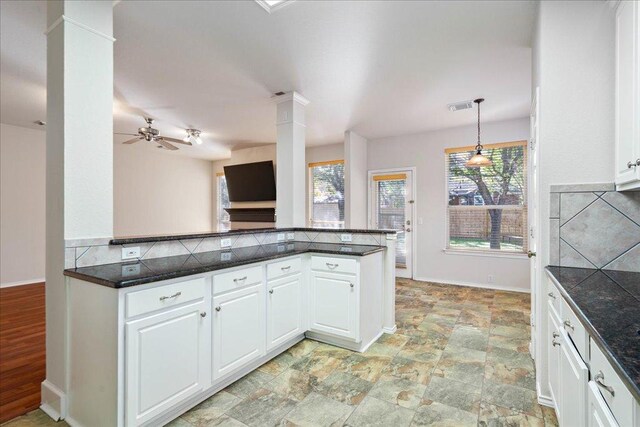kitchen with visible vents, tasteful backsplash, white cabinetry, and decorative columns