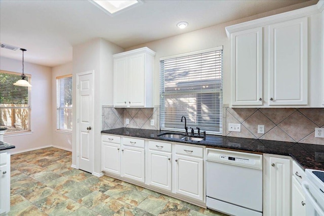 kitchen with decorative backsplash, white cabinets, dishwasher, a sink, and visible vents