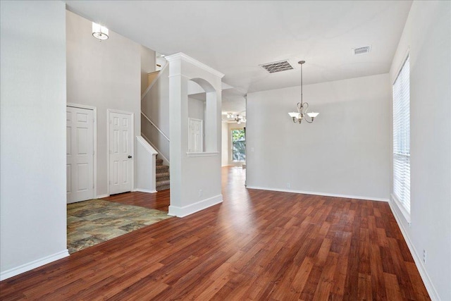 interior space with stairway, wood finished floors, visible vents, and a chandelier