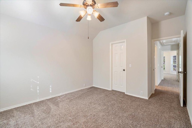 empty room featuring attic access, ceiling fan, baseboards, and carpet floors