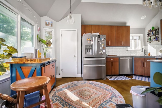 3011 Foxton Cv, Austin, TX 78748 - kitchen featuring stainless steel appliances, vaulted ceiling, brown cabinets, decorative backsplash, and a sink
