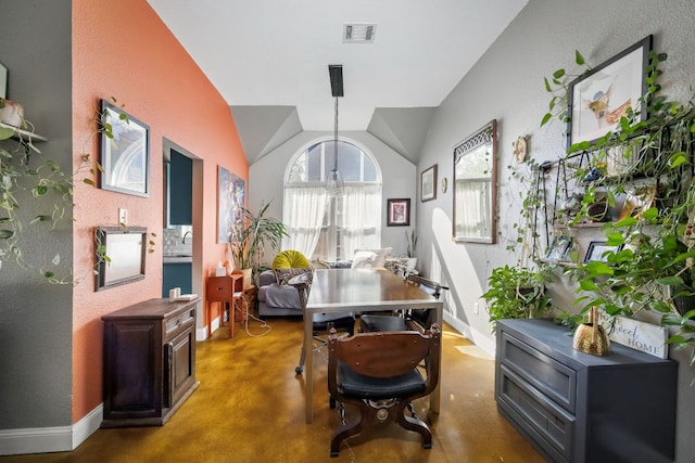 3011 Foxton Cv, Austin, TX 78748 - dining room featuring finished concrete flooring, baseboards, and vaulted ceiling