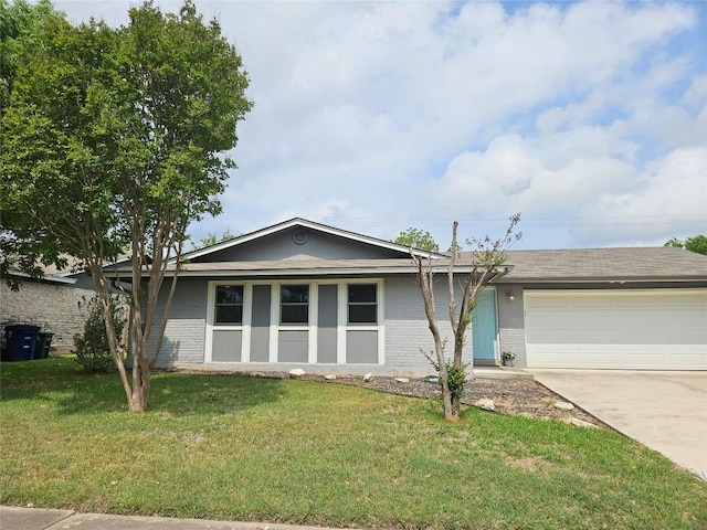 single story home featuring brick siding, a front lawn, concrete driveway, and an attached garage