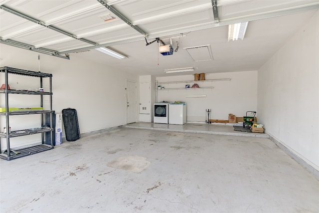 garage featuring separate washer and dryer and a garage door opener