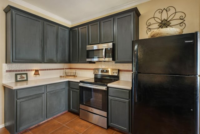 kitchen featuring stainless steel appliances, tasteful backsplash, crown molding, light countertops, and dark tile patterned flooring