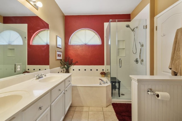 bathroom featuring a garden tub, a stall shower, a sink, and a wealth of natural light