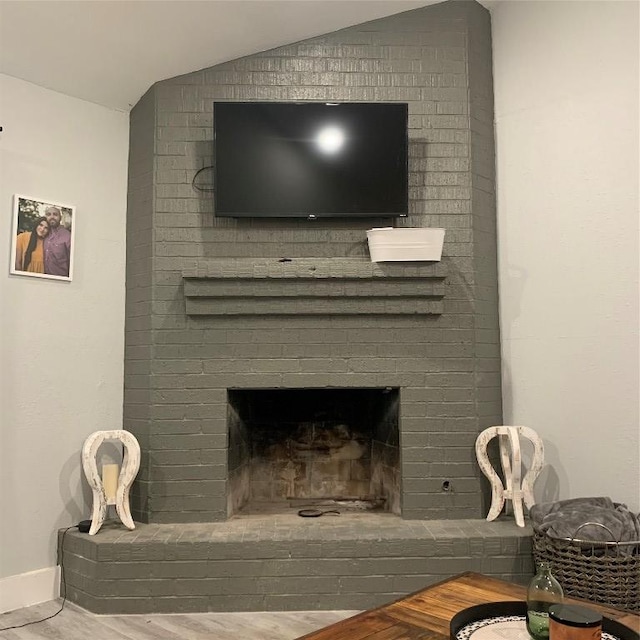 724 Woodcrest Cir, New Braunfels, TX 78130 - detailed view of a brick fireplace, baseboards, and wood finished floors