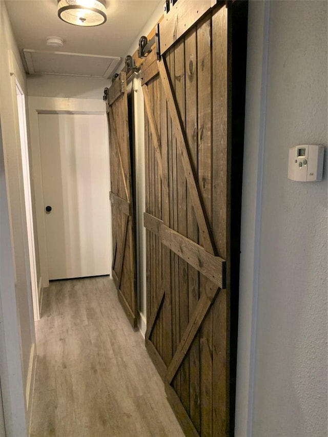 724 Woodcrest Cir, New Braunfels, TX 78130 - hall featuring light wood-style floors and a barn door