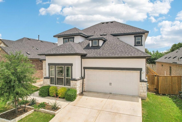 view of front of property featuring concrete driveway, stone siding, stucco siding, and a shingled roof