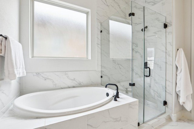 full bathroom with a garden tub, a marble finish shower, and marble finish floor