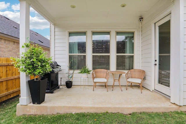 view of patio / terrace with a grill and fence