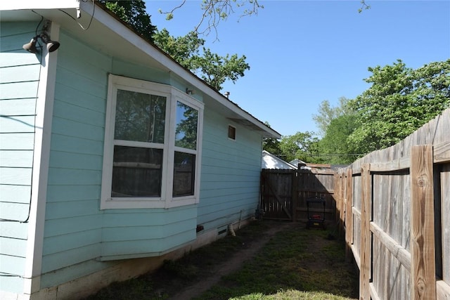 1200 NE 5th St, Smithville, TX 78957 - view of home's exterior with crawl space and fence