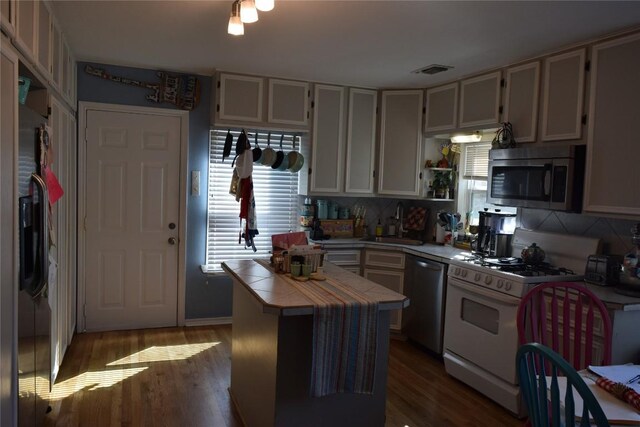 1200 NE 5th St, Smithville, TX 78957 - kitchen featuring stainless steel appliances, a healthy amount of sunlight, tile counters, and a sink