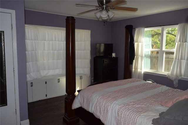 1200 NE 5th St, Smithville, TX 78957 - bedroom with dark wood-style floors and a ceiling fan