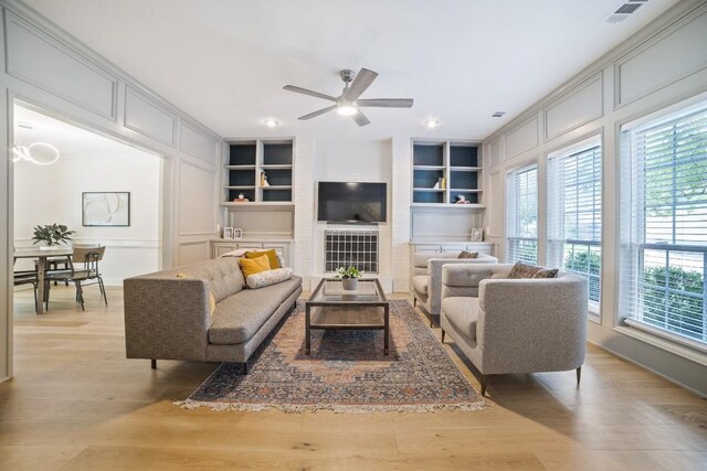 1702 Crested Butte Dr, Austin, TX 78746 - living room with built in features, a ceiling fan, and light wood-style floors